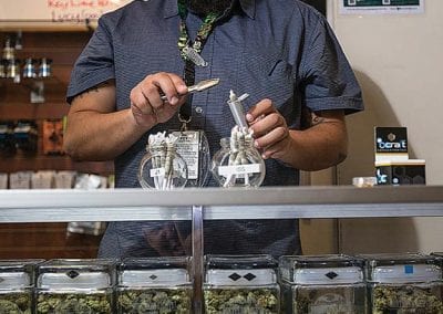 Digital 303 Marijuana Photographer: Budtender Selling Cannabis Products